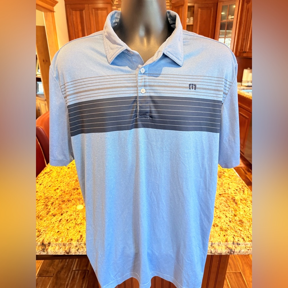 Travis Mathew men’s golf polo. Sharp blue & grey striped with logo.